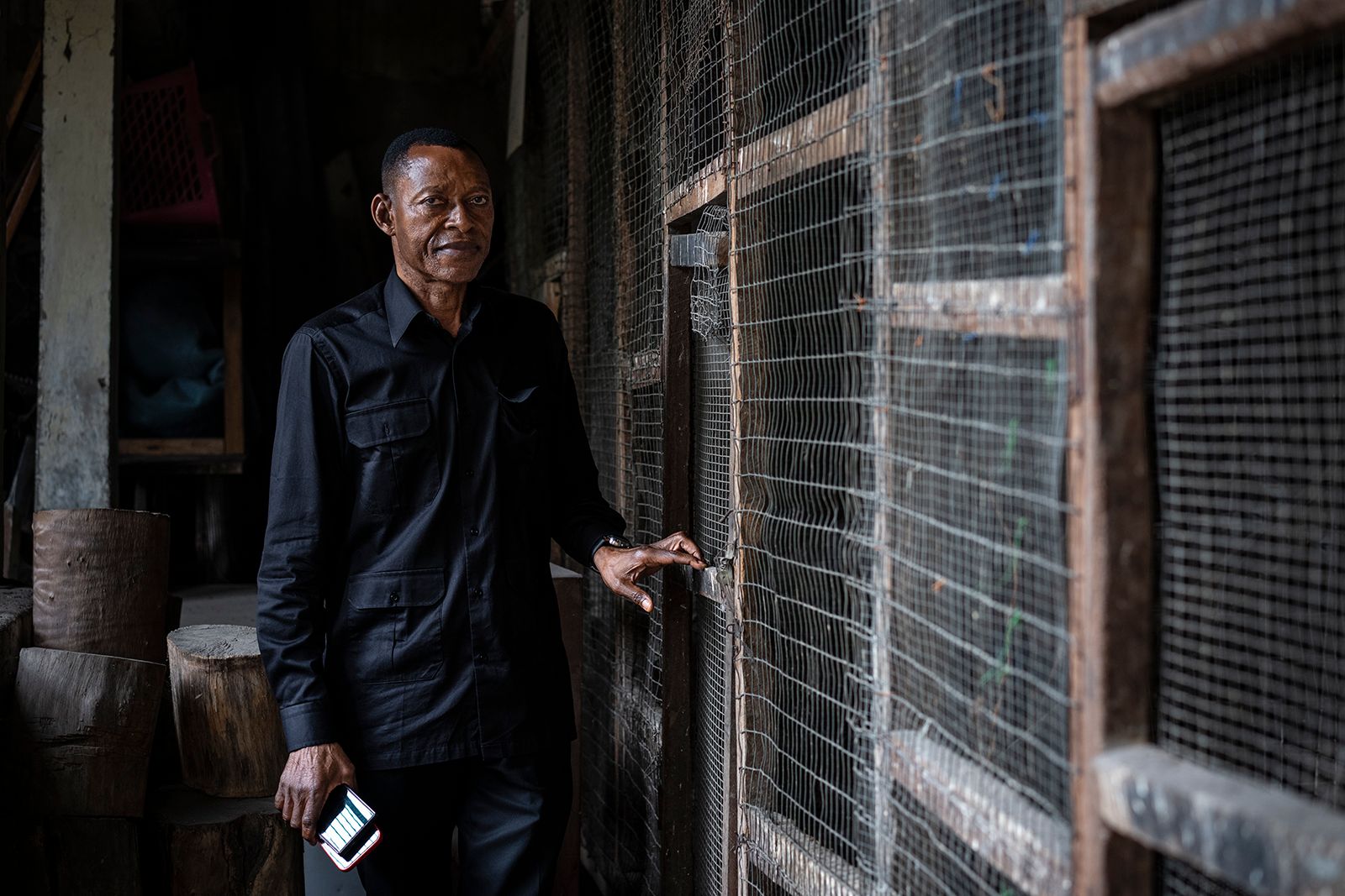 Man standing next to cages